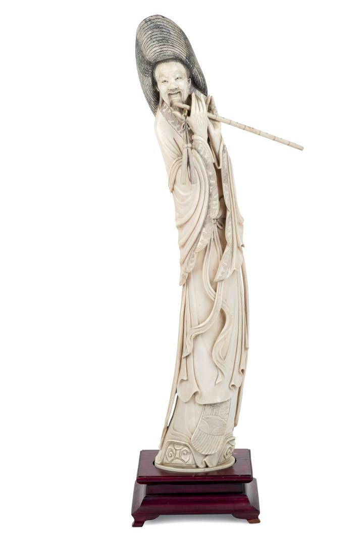 Ivory flute player carving.