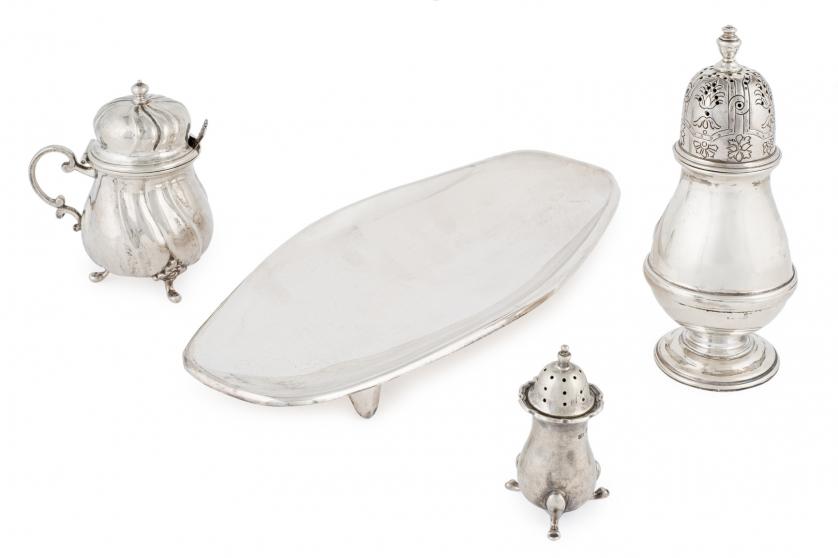 A silver tray and three sugar bowls